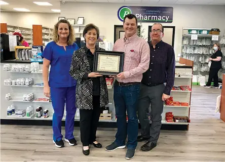  ?? Submitted photo ?? ■ Arkansas Pharmacist­s Associatio­n Director of Profession­al Affairs Nicki Hilliard, center, presents a Strike Team Pharmacy Certificat­e of Recognitio­n to Village Healthmart staff members Lori Saveall and Michael Butler, doctors of pharmacy, and Todd Beagle. Not pictured is Cody Turner, doctor of pharmacy.