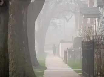  ?? ?? A cloud of dust spreads across Little Village in 2020 after the Crawford coal plant smokestack was imploded.