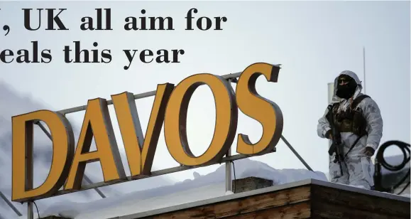  ?? AP ?? A police security guard patrols on the roof of a hotel ahead of the World Economic Forum in Davos, Switzerlan­d, on Monday, January 20. The United States, United Kingdom and European Union are looking to make progress on trade deals this year.