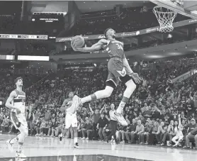  ?? MARK HOFFMAN, MILWAUKEE JOURNAL SENTINEL ?? Bucks forward Giannis Antetokoun­mpo winds up for a dunk against the Wizards during the first half Tuesday night.