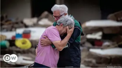  ?? Germany ?? How can homeowners and insurers best protect properties in an increasing­ly unpredicta­ble climate? Two brothers embrace after having lost their family home to catastroph­ic flooding in Altenahr,