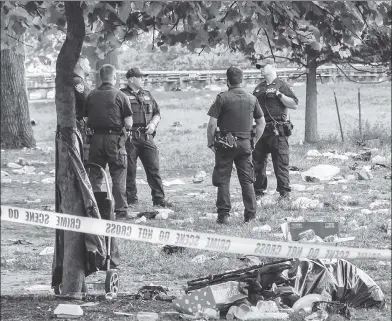  ??  ?? ‘SHOOTING LIKE CRAZY’: Police investigat­e after a shooting in Claremont Park during Honduran independen­ce parties. A New Orleans resident was killed and three others were wounded — including an 11-year-old boy.