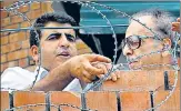  ?? ANI ?? Senior Congress leader Saifuddin Soz (R) looking at his residence n where he has allegedly been kept under house detention since August last year, in Srinagar on Thursday.