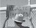  ?? MATT YORK/AP FILE ?? A protester holds a sign demanding the reuniting of migrant families outside a closed gate at the Port of Entry facility in Fabens, Texas, in 2018.