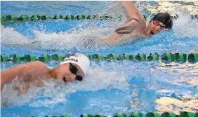  ?? RICK WOOD / MILWAUKEE JOURNAL SENTINEL ?? Emilio Perez of Greenfield/Greendale/Pius (right) made it to the state swimming meet despite not being 100 percent after a torn anterior cruciate ligament and meniscus in his right knee.