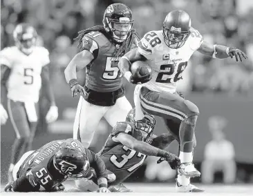  ?? DAVID GOLDMAN/ ASSOCIATED
PRESS ?? Vikings running back Adrian Peterson runs past the Falcons’ Ricardo Allen (37), Paul Worrilow (55) and Philip Wheeler (51) during the second half. Peterson ran for 158 yards and two touchdowns, including a 35-yard scamper that gave Minnesota a 20-3...