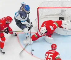  ?? DMITRI LOVETSKY/THE ASSOCIATED PRESS ?? Patrik Laine, seen trying to jam the puck past Belarus goalie Vitali Koval on Friday, leads the World Hockey Championsh­ip tournament with four goals and six points.