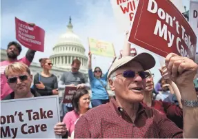 ?? ALEX WONG/GETTY IMAGES ?? Activists hold a “Stop Trumpcare” rally May 4, 2017, to protest Republican attempts to replace Obamacare.