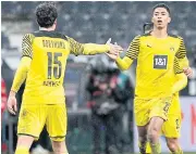  ?? AFP ?? Dortmund’s Jude Bellingham, right, celebrates his goal against Frankfurt with Mats Hummels.