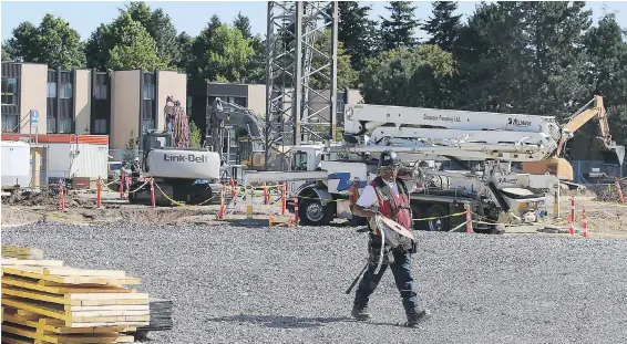  ??  ?? Constructi­on takes place this week on the University of Victoria campus, where student residences, a dining room and other facilities are being built.