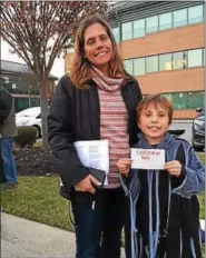  ?? SUSAN SERBIN – DIGITAL FIRST MEDIA ?? Cathy Spahn took the Christmas Carol theme at Sunday’s tax cut plan protest outside the office of U.S. Rep. Pat Meehan, R-7, seriously. She made a Ghost of Christmas Past costume for her son Julien.