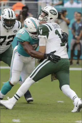  ?? LYNNE SLADKY — THE ASSOCIATED PRESS ?? Dolphins defensive end Cameron Wake sacks Jets quarterbac­k Sam Darnold during the first half of Sunday’s game in Miami.