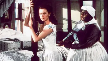  ??  ?? A dark film history: a scene from ‘Gone With the Wind’, starring Vivien Leigh as Scarlett O’Hara and Hattie Mcdaniel as house servant/slave Mammy, an archetype role that garnered Mcdaniel the first Oscar for an african american performer . –MGM/RC