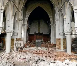  ??  ?? Rubble is heaped in what was once the interior of the cathedral. ‘‘It is eerie. It is beautiful. It is touching and it is telling.’’