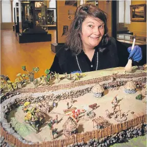  ?? Picture: Steve MacDougall. ?? Christina Donald, curator of early history, with the model.