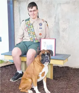  ?? COURTESY PHOTO ?? Newly minted Eagle Scout Raymond Boyer and his dog, Scout, at Ray's project site at the Old Mill High School complex.