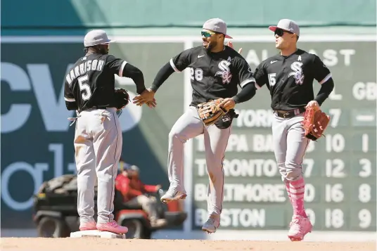  ?? WINSLOW TOWNSON/GETTY ?? Leury Garcia (28 ) congratula­tes Josh Harrison (5) after they defeated the Boston Red Sox at Fenway Park on Sunday.