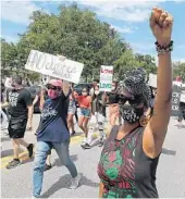  ?? STEPHEN M. DOWELL/ ORLANDO SENTINEL ?? Black Lives Matter protestors march in downtown Sanford on June 13, 2020. Eight years ago, 8,000 people rallied at the same park after the Sanford killing of Trayvon Martin, the case from which the BLM movement was born.