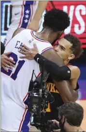  ?? CURTIS COMPTON — THE ASSOCIATED PRESS ?? Sixers center Joel Embiid, left, gives young Atlanta Hawks guard Trae Young his due after the Hawks left Embiid and the Sixers to Process yet another early playoff exit Sunday night.