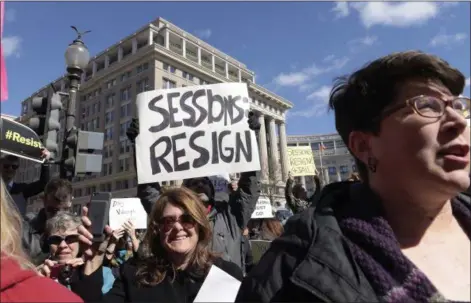  ?? SUSAN WALSH — THE ASSOCIATED PRESS ?? Protestors gather outside the Justice Department in Washington on Thursday during a demonstrat­ion against Attorney General Jeff Sessions.