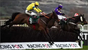  ??  ?? Jamie Codd and Ravenhill locked in battle with Sam Waley Cohen and Lord Du Mesnil after jumping the last,