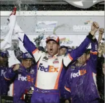  ?? JOHN RAOUX — THE ASSOCIATED PRESS ?? Denny Hamlin celebrates in Victory Lane after winning the NASCAR Daytona 500 auto race at Daytona Internatio­nal Speedway, Sunday in Daytona Beach, Fla.