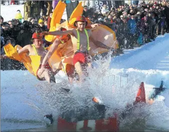  ?? PETRA MALUKAS / AGENCE-FRANCE PRESSE ?? Costumed participan­ts leap into an ice-cold pond at the Jump and Freeze event in Vilnius, Lithuania, on Saturday.