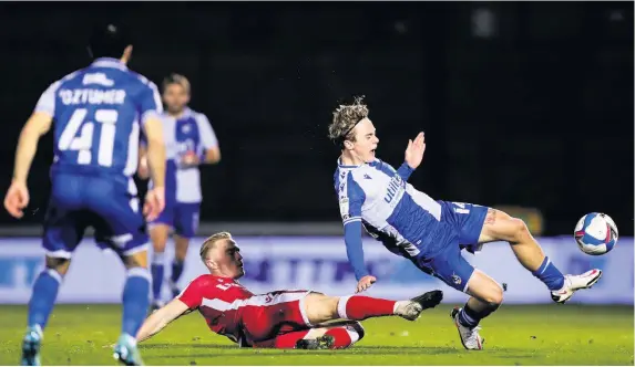  ?? Pictures: Rogan Thomson/JMP ?? Rovers midfielder Luke McCormick feels the full force of a challenge from Gillingham’s Kyle Dempsey