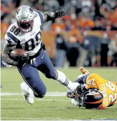 ?? JACK DEMPSEY/THE ASSOCIATED PRESS ?? New England Patriots tight end Martellus Bennett is tripped up by Denver Broncos free safety Darian Stewart during their game on Sunday. Bennett is still coming to terms with how his Green Bay tenure ended. But he says being back in familiar...