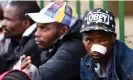  ?? ?? Survivors outside 80 Albert Street. Photograph: Siphiwe Sibeko/Reuters