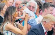  ?? REUTERS ?? First Lady Melania Trump holds a baby as US President Donald Trump greets members of the congress at the White House.