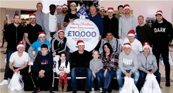  ??  ?? Christmas cheer: The Ibrox first-team squad visited the Royal Hospital for Children in Glasgow yesterday — handing over £10,000 on behalf of the Rangers Charity Foundation to buy a specialist laser pen to help treat oral mucositis, a debilitati­ng side effect of chemothera­py