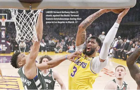  ??  ?? LAKERS forward Anthony Davis (3) shoots against the Bucks’ forward Giannis Antetokoun­mpo during their game in Los Angeles in March.