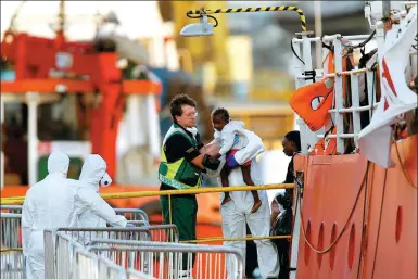  ?? DARRIN ZAMMIT LUPI / REUTERS ?? A migrant child is carried from the charity ship Lifeline at Boiler Wharf in Senglea, in Valletta’s Grand Harbour, Malta, on Wednesday.