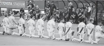  ?? USA TODAY SPORTS ?? FC Dallas players and Nashville SC players kneel during the national anthem before their match at Toyota Stadium in Dallas on Aug. 12, 2020.