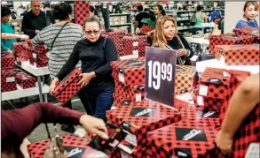  ?? Orange County Register/NICK AGRO ?? Shoppers peruse boots on sale at a J.C. Penney Co. store late last year in Laguna Hills, Calif. The Labor Department reported Wednesday that for all of 2016, prices were up 2.1 percent.