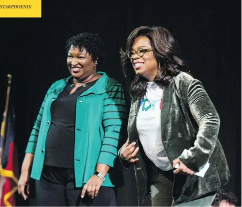  ?? JESSICA MCGOWAN / GETTY IMAGES ?? Oprah Winfrey and Georgia Democratic gubernator­ial candidate Stacey Abrams greet the audience during a gathering at the Cobb Civic Center on Thursday in Marietta, Ga. Winfrey travelled to the state to campaign with Abrams ahead of next Tuesday’s midterm elections.