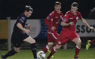  ??  ?? Wexford winger Owen Wall taking on the Shelbourne defence.