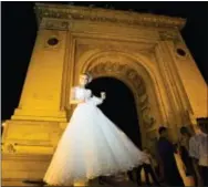  ?? VADIM GHIRDA — THE ASSOCIATED PRESS FILE ?? In this file photo, a Romanian bride poses for pictures at the Triumph Arch, a replica of the Arc de Triomphe in Paris, the French capital, in Bucharest, Romania.