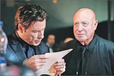  ?? CHRISTOPHE­R POLK Getty Images ?? PAUL BLOCH, right, with client John Travolta at the 2014 Oscars, when the actor famously f lubbed his intro.