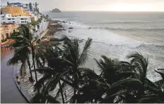  ?? Reuters ?? Palm trees sway in Mazatlan, a tranquil resort town. Hotels that line the coast were empty as thousands fled Willa.