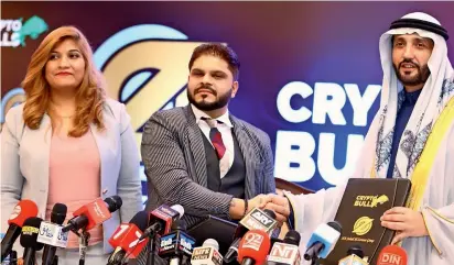  ?? — Supplied photo ?? Madhu, Shasha Gupta and Suhail Al Zarooni after signing an agreement to launch the Crypto Bulls Exchange in Dubai, the first cryptocurr­ency exchange to be registered in the UAE.