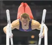  ??  ?? MIKULAK, 28, competes on the parallel bars during the U.S. Olympic trials in June in St. Louis.