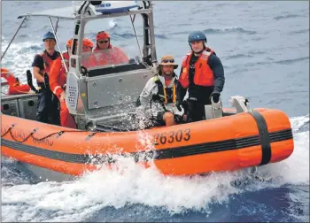  ??  ?? A coastguard crew transfers Niall Iain to their cutter by RIB.