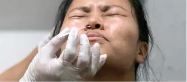  ?? Associated Press ?? ↑
A health worker takes a nasal swab sample from a woman in Kohima, Nagaland, on Wednesday.