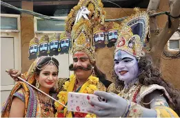  ?? — PTI ?? Artistes dressed as Lord Krishna, Radha and Ravana take a selfie during the 32nd Internatio­nal Art and Crafts Mela at Surajkund in Faridabad on Thursday.