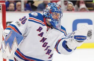  ?? PAUL SANCYA/ASSOCIATED PRESS ?? Rangers goalie Henrik Lundqvist stops a Detroit shot during Sunday’s game. Lundqvist made 21 saves for the 61st shutout of his career.
