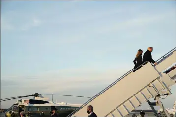  ?? ERIN SCOTT — THE NEW YORK TIMES ?? President Donald Trump and first lady Melania Trump board Air Force One at Joint Base Andrews in Maryland on Wednesday.
