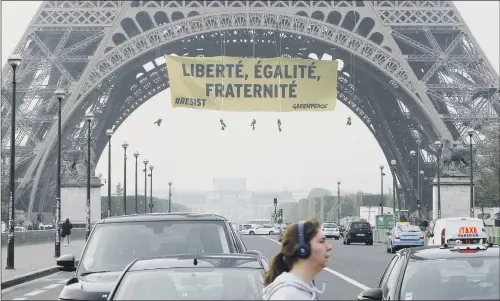  ??  ?? Greenpeace activists display a banner in protest against far-right presidenti­al candidate Marine Le Pen two days before the runoff.