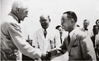  ?? ?? (Above) Chia Lay Phor being congratula­ted by Colonial Secretary Patrick A.B Mckerron upon the completion of the Kallang Airport runways extension, 1949. Courtesy of Joseph Chia.